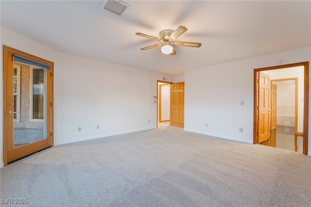 empty room featuring ceiling fan and light colored carpet