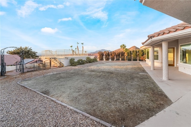 view of yard with a mountain view and a patio area