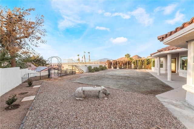 view of yard featuring a mountain view and a patio