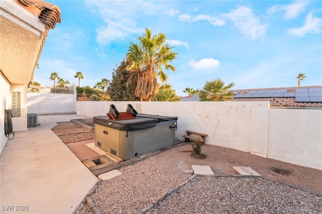 view of yard with a hot tub, a patio, and central AC unit