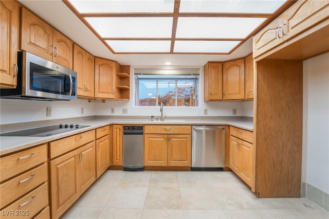 kitchen with appliances with stainless steel finishes, sink, and light tile patterned floors