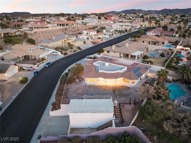 aerial view at dusk featuring a mountain view