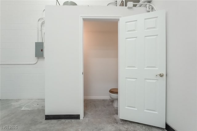 bathroom with concrete floors and toilet