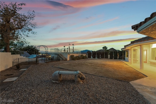 playground at dusk featuring a patio