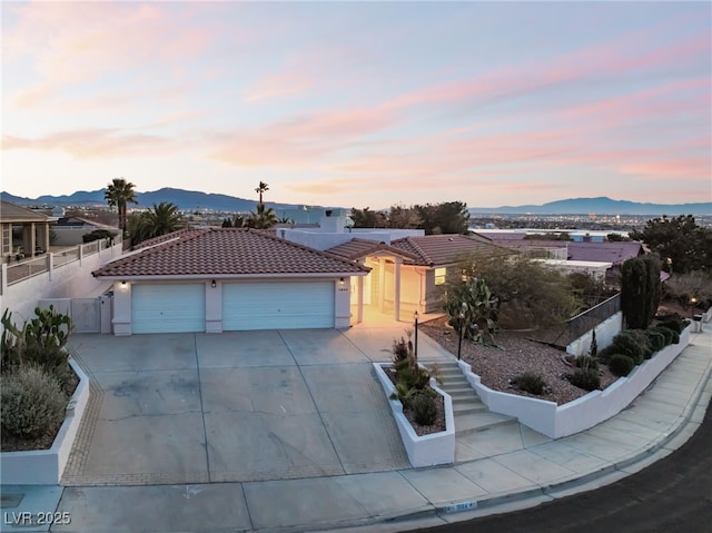 view of front of house featuring a garage and a mountain view