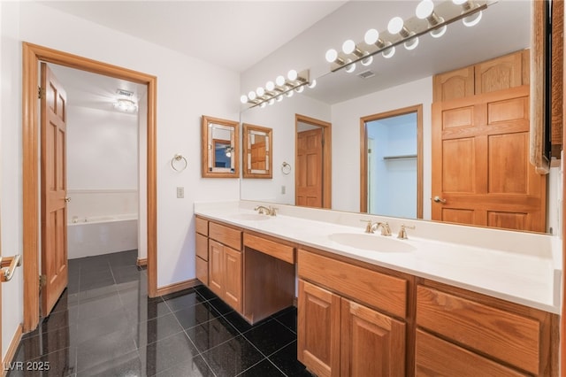 bathroom featuring tile patterned flooring, vanity, and a bath