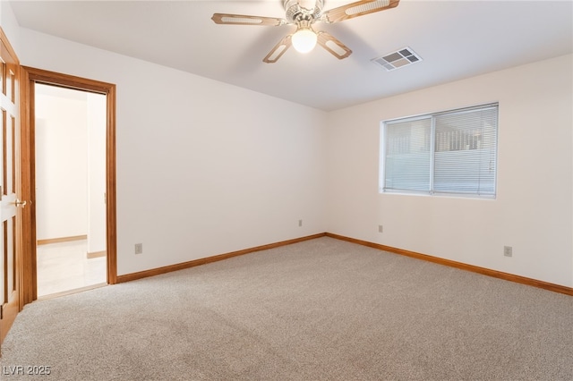 unfurnished room featuring light colored carpet and ceiling fan