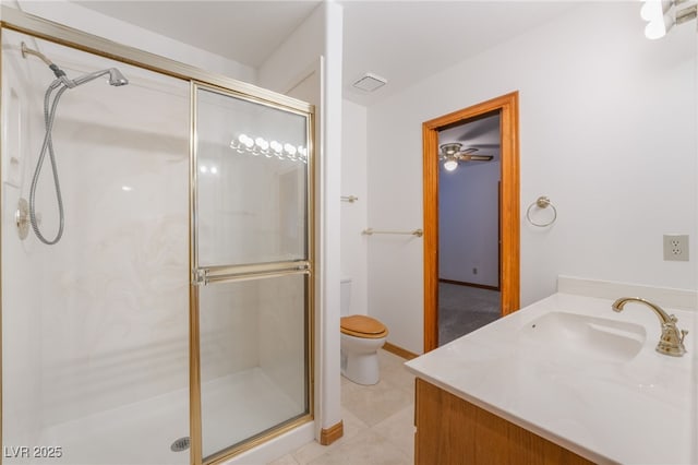 bathroom with an enclosed shower, vanity, tile patterned flooring, and toilet