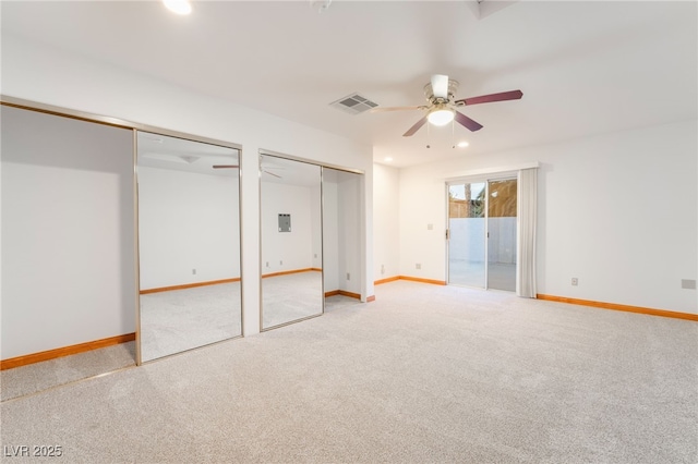 unfurnished bedroom featuring ceiling fan, access to exterior, carpet floors, and two closets