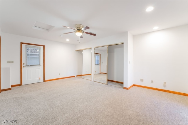 interior space featuring ceiling fan and light colored carpet