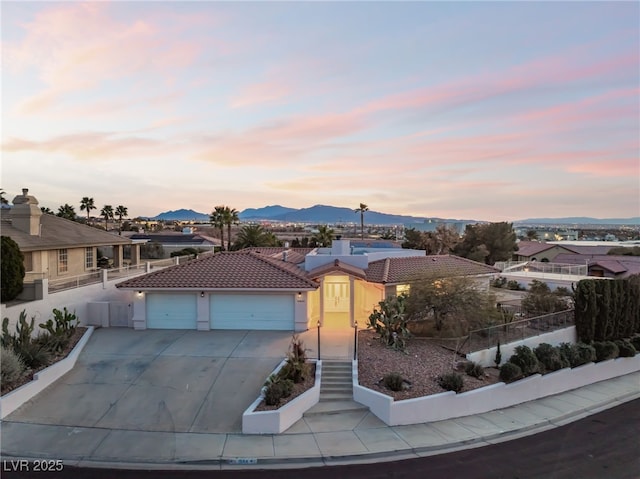 view of front facade with a mountain view and a garage