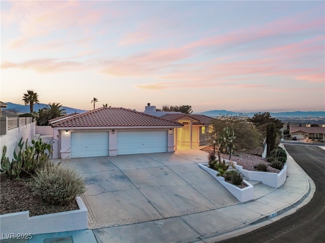 view of front of house with a mountain view and a garage