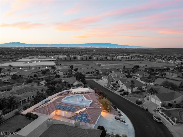 aerial view at dusk featuring a mountain view