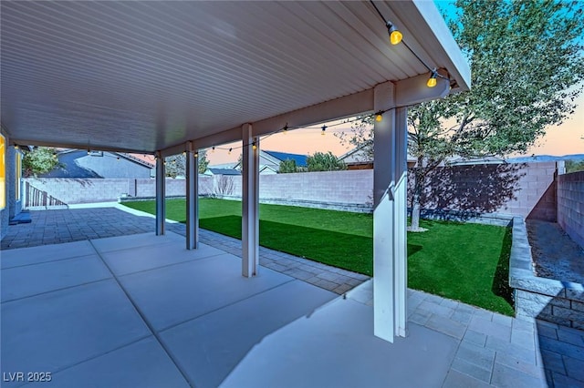 patio terrace at dusk with a lawn