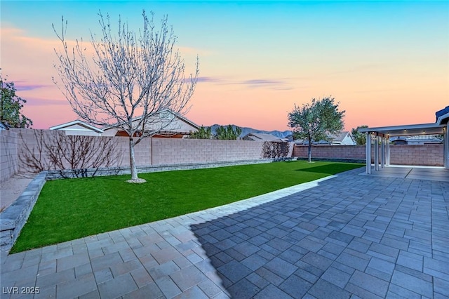 yard at dusk with a patio