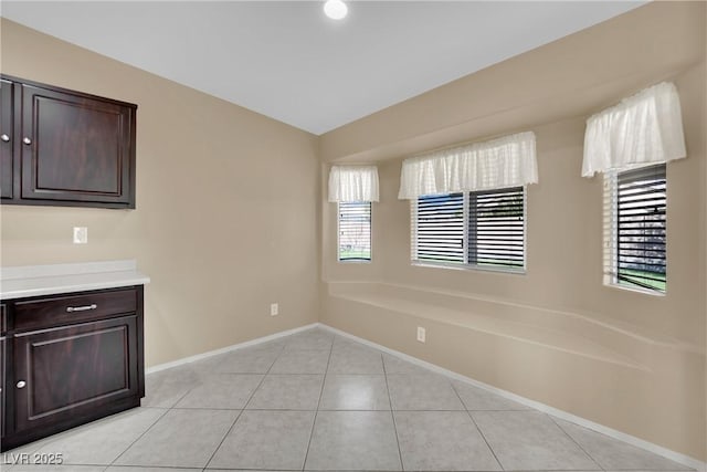 unfurnished dining area featuring light tile patterned floors