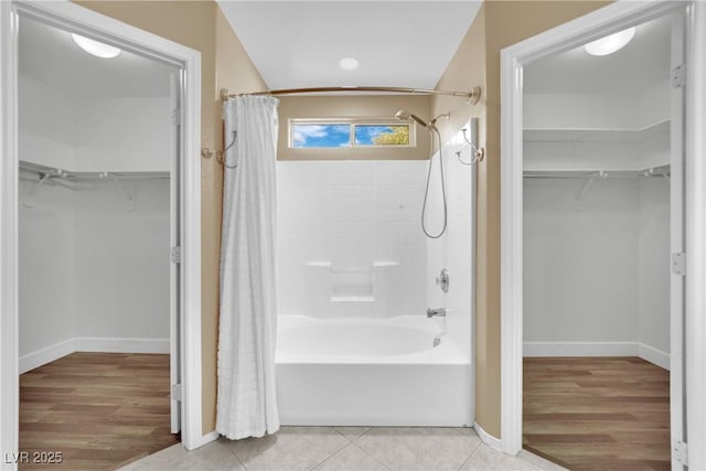 bathroom featuring hardwood / wood-style flooring and shower / bath combo with shower curtain