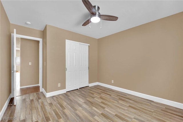 unfurnished bedroom featuring light hardwood / wood-style floors, a closet, and ceiling fan