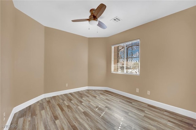 spare room with ceiling fan and light hardwood / wood-style floors