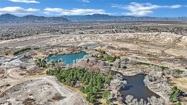 drone / aerial view featuring a water and mountain view