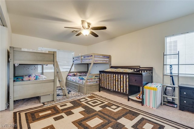 bedroom with ceiling fan and light colored carpet