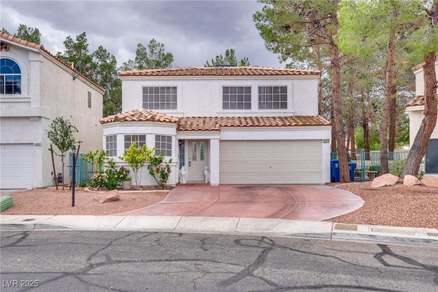 mediterranean / spanish home with a garage