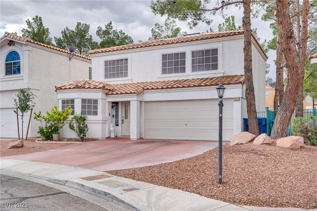 mediterranean / spanish home featuring a garage