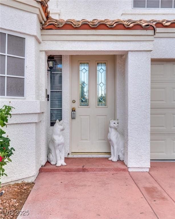 view of exterior entry with a garage