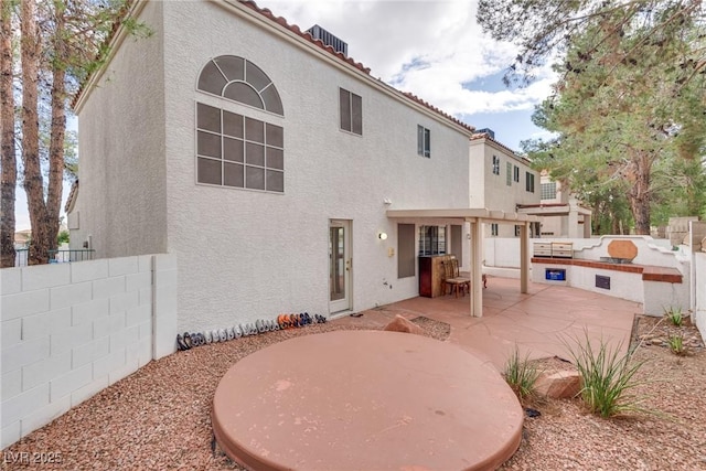 back of property featuring a patio