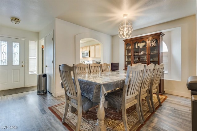 dining area featuring a notable chandelier and wood-type flooring