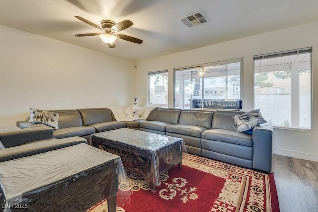 living room with hardwood / wood-style flooring and ceiling fan