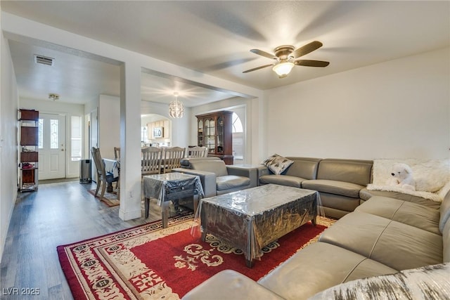 living room featuring wood-type flooring and ceiling fan