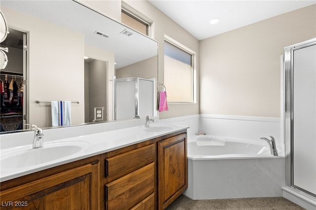 bathroom featuring vanity and separate shower and tub