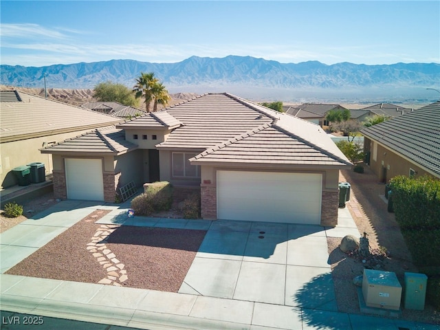 view of front of home with a mountain view, a garage, and central air condition unit