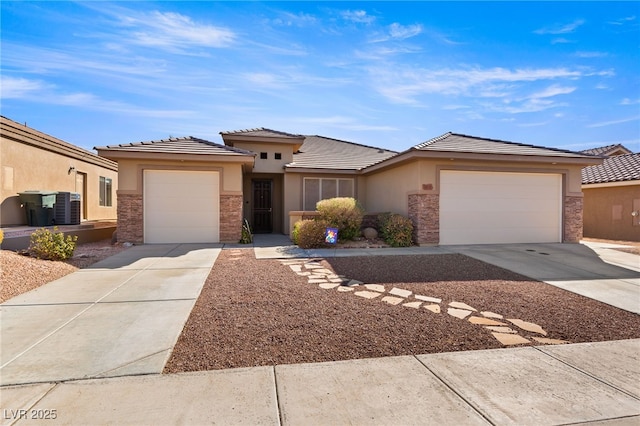 prairie-style home featuring a garage and central AC