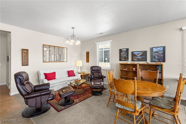 living room featuring a notable chandelier and a textured ceiling