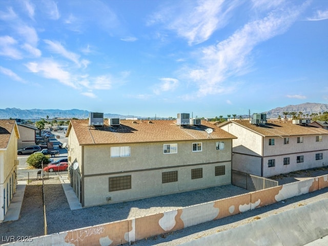 view of property exterior featuring cooling unit and a mountain view