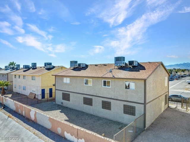 view of side of home with central AC unit