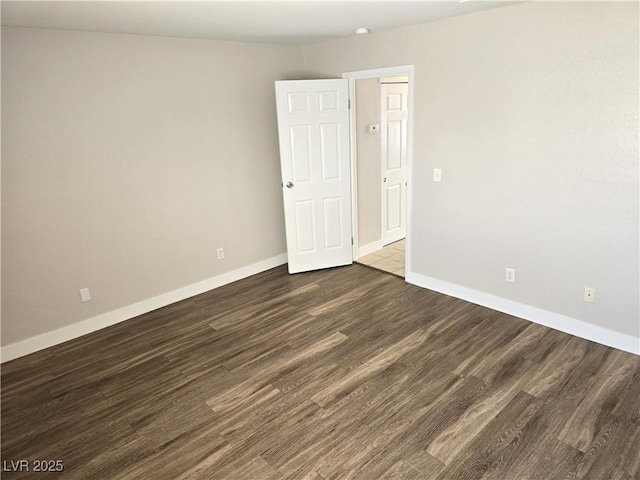 spare room with dark hardwood / wood-style flooring