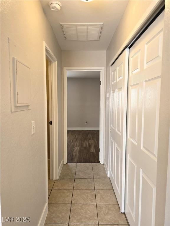 corridor with light tile patterned floors