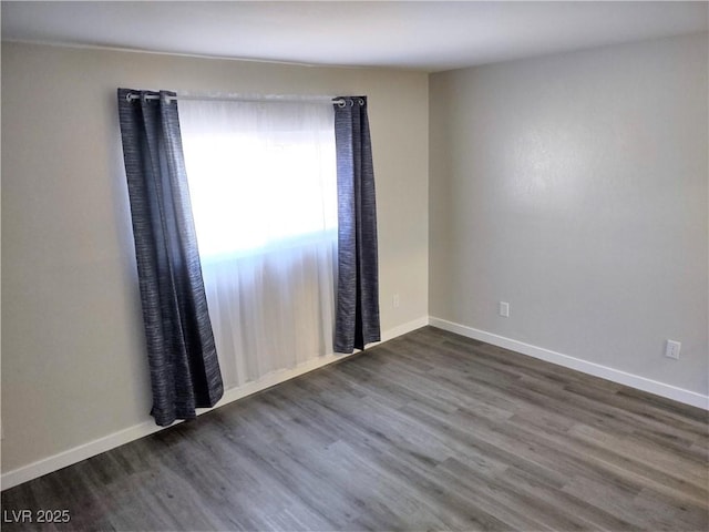 unfurnished room with hardwood / wood-style flooring