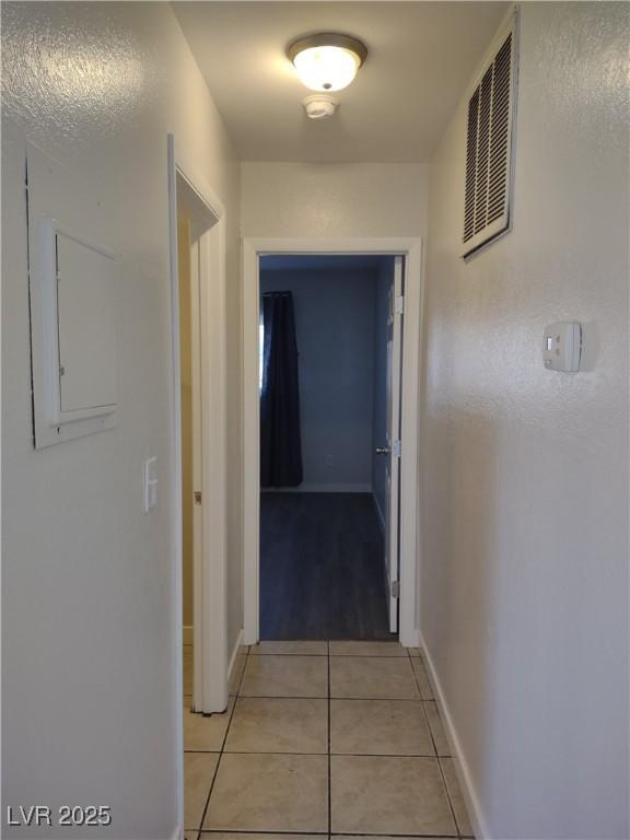 corridor featuring light tile patterned flooring