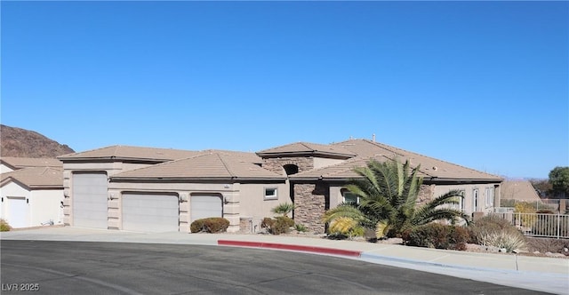 view of front of house with a garage and a mountain view