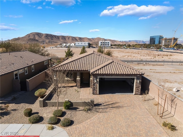 view of front of property with a garage and a mountain view