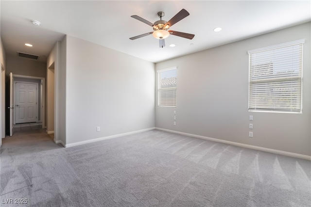 carpeted spare room featuring ceiling fan