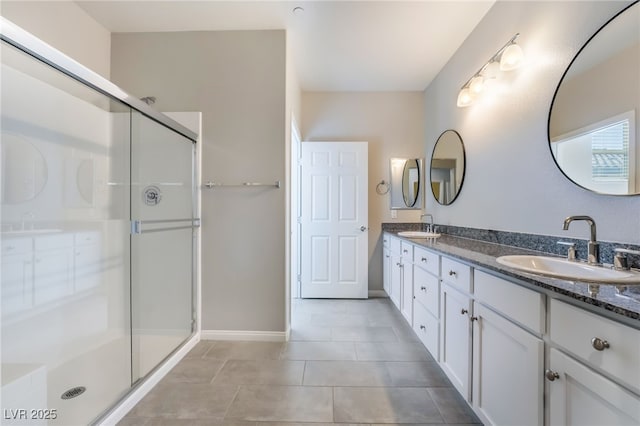 bathroom featuring tile patterned floors, a shower with door, and vanity