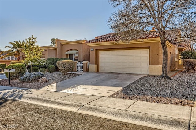 mediterranean / spanish home with concrete driveway, a tiled roof, an attached garage, and stucco siding