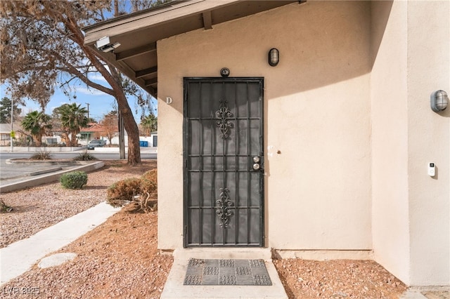 doorway to property with stucco siding