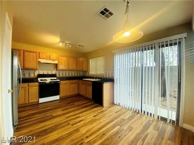 kitchen featuring stainless steel refrigerator, sink, range with gas cooktop, and light hardwood / wood-style flooring