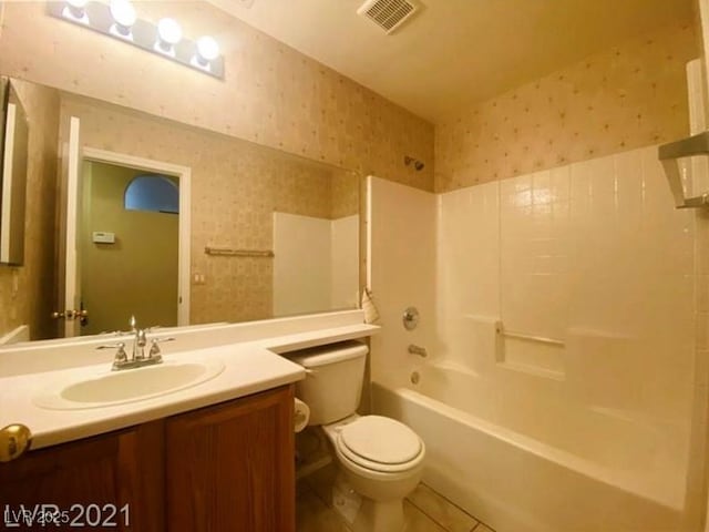 full bathroom with vanity, tub / shower combination, tile patterned floors, and toilet